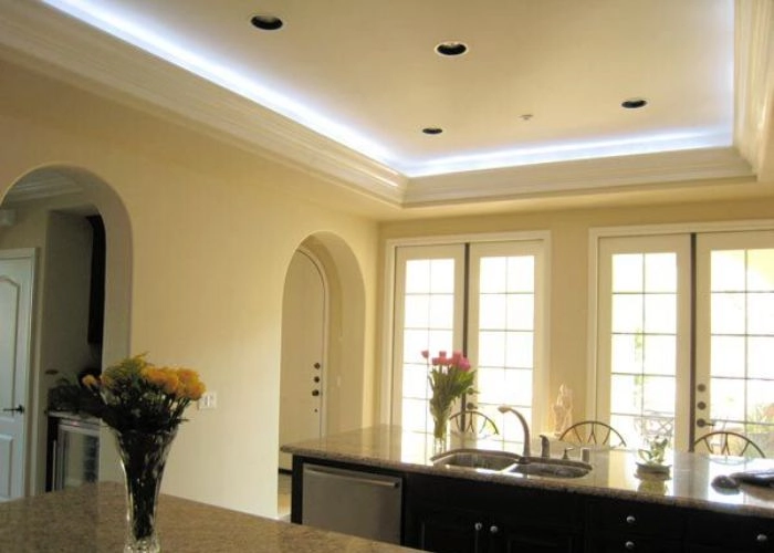 Clean white kitchen soffit with spotlights