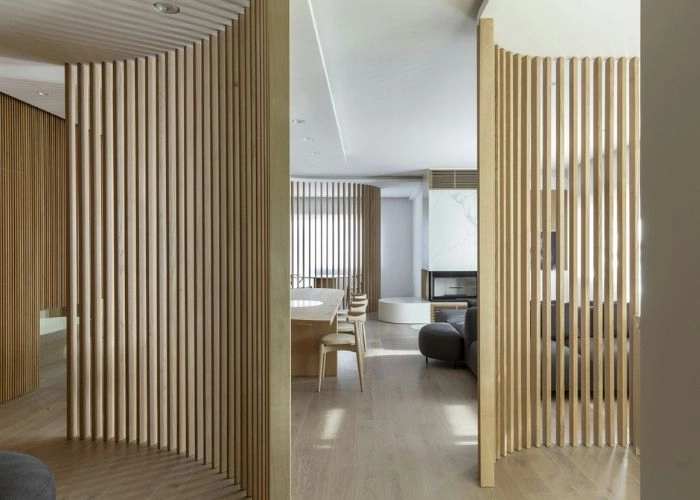 Hand-carved traditional wooden partition at entry.